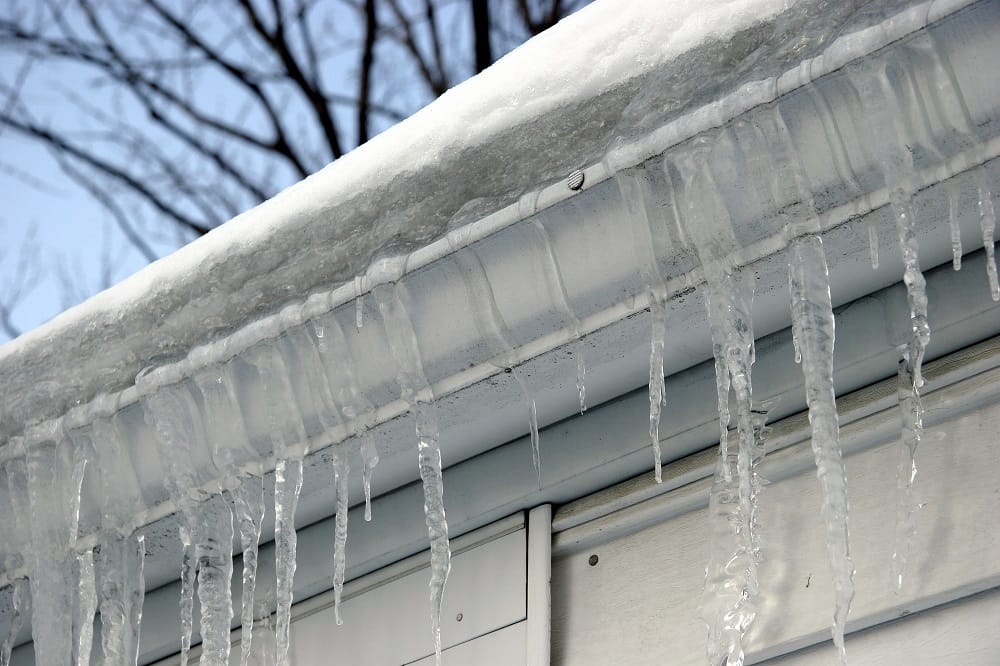 Ice Covering House Gutters During Winter | Piedmont Roofing